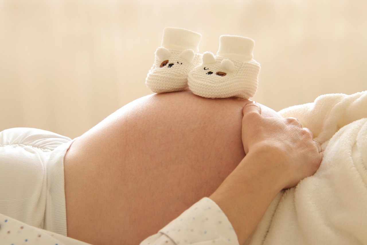 A pregnant woman holding her baby bump